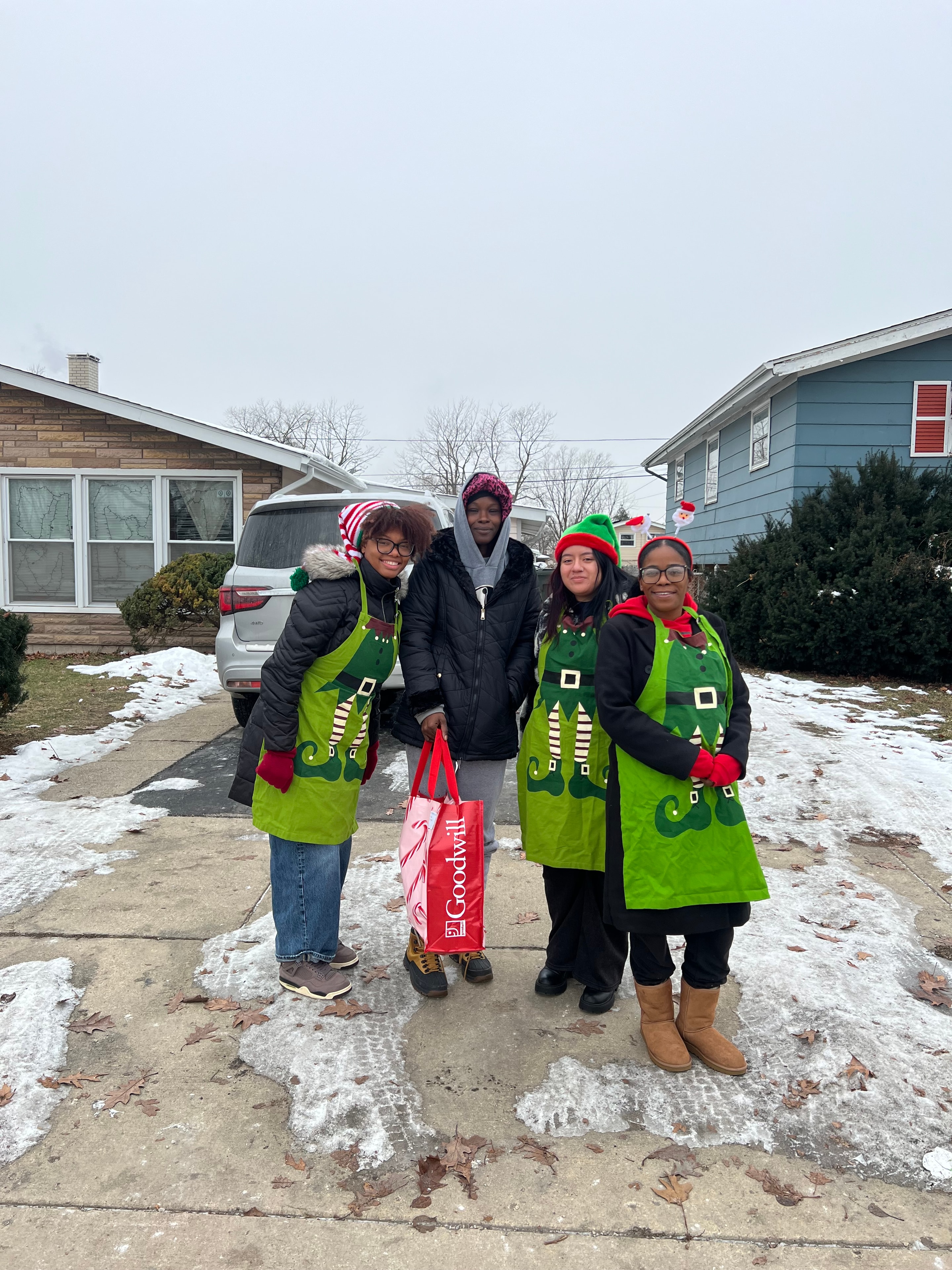 Volunteers in elf costumes delivering gifts