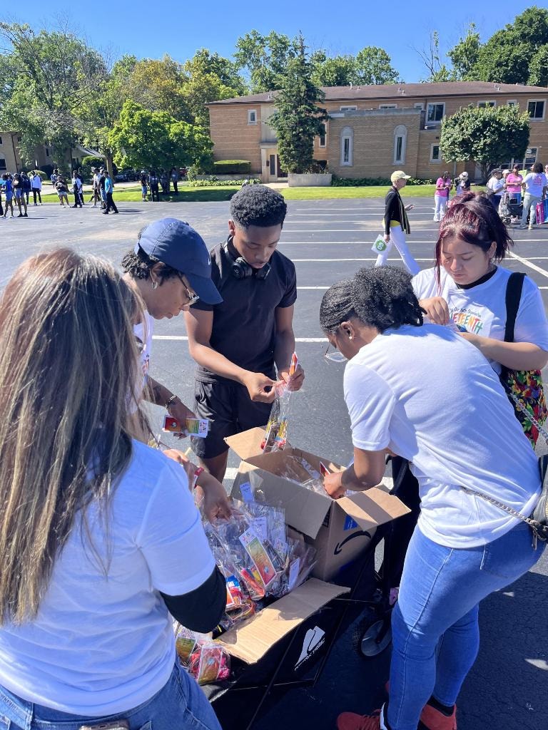 Volunteers distributing supplies at outdoor Juneteenth community event