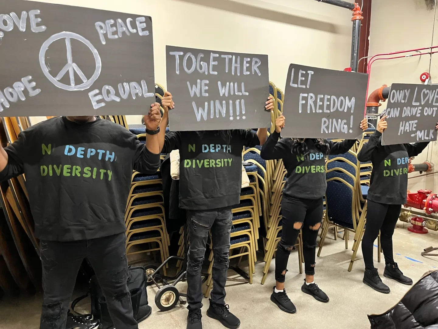Youth advocates holding signs at community event
